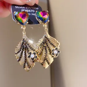 Detail of rainbow heart S925 silver needle gold leaf tassel earrings with pearls.