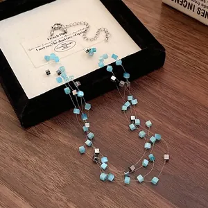 Multi-layered square cat's eye stone necklace featuring blue cubes and silver accents