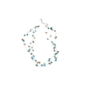 Elegant multi-layered necklace featuring blue and gold square cat's eye stone beads on white