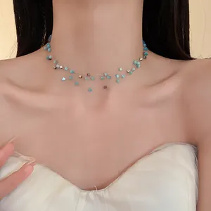 Close-up of a multi-layer necklace featuring light blue square cat-eye stone beads