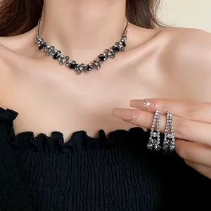 Detail shot of the shimmering black and silver rhinestone jewelry set on a model