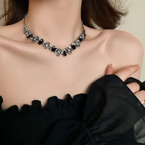 Close-up of elegant water drop black rhinestone necklace on model for a chic fashion look