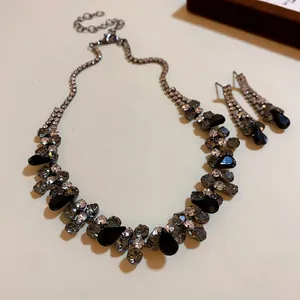 Close-up view of elegant black waterdrop rhinestone necklace and matching earring set.