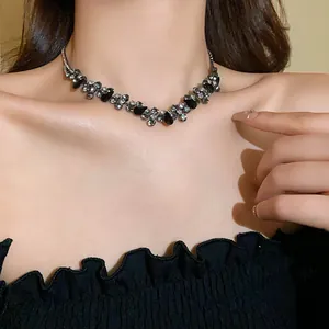Close-up view of an elegant black waterdrop stone choker necklace worn on the neck