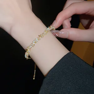 Close-up of elegant minimalist pearl and crystal bracelet worn on a woman's wrist.