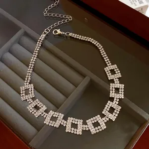 Macro view showing the sparkling detail of this rhinestone double-layered square motif necklace