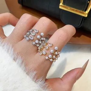 Elegant multilayer open ring featuring teardrop zircons and delicate pearls.