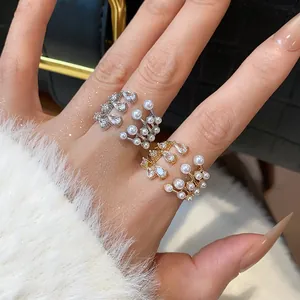 Close-up detail of multi-layer open ring with teardrop zircons and white pearls