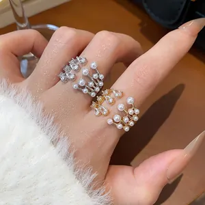 Detailed view of layered open rings featuring elegant zircons and pearls for women