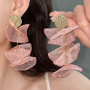 Detail view showing the layered pink chiffon petals of these elegant floral earrings.