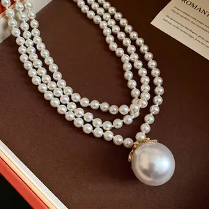 Multi-strand faux pearl necklace with large pendant pearl in French retro style