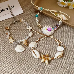 Close-up detail of handmade bohemian bracelets with shells, starfish, and natural stones.