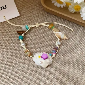 Detailed close-up of handmade vacation style bracelet with natural stones and sea shells
