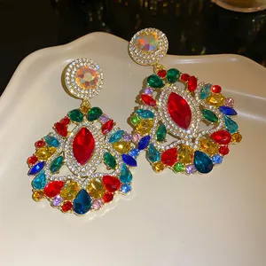 Detailed macro shot of vintage-style gold earrings with vibrant multi-colored gemstones.