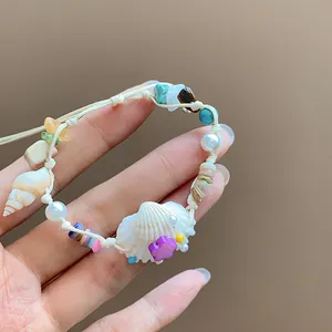 Detailed shot of handmade vacation bracelet with natural stones, pearls and seashell