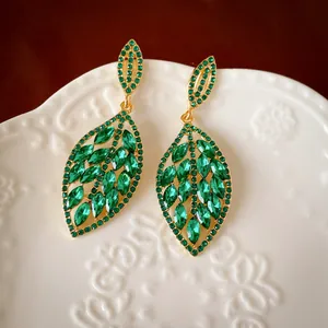 Elegant vintage gold-plated drop earrings with marquise-cut green crystals in leaf design