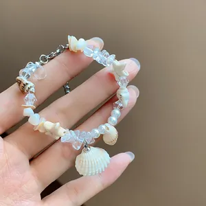 Detailed view of natural stone beaded bracelet with seashell and pearl charms