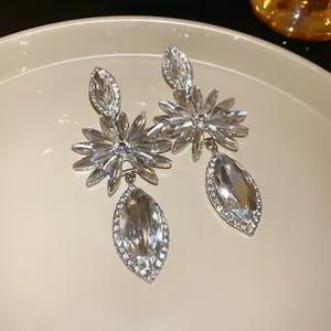 Detailed macro view of luxurious crystal-encrusted floral earrings with marquise stones