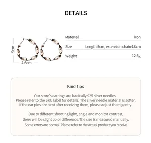 Detailed view of twisted spiral hoop earrings with size specifications and material info.