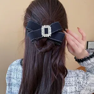 Elegant black fabric bow hair clip with sparkling rhinestone buckle for bridal hairstyles