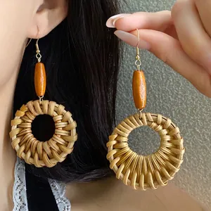 Vintage ethnic style woven rattan round earrings with orange wood bead details