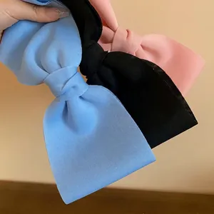 Elegant Korean style large fabric bow hair clips in blue, black, and pink colors