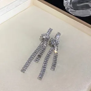 Elegant silver needle knotted tassel drop earrings with sparkling rectangular cubic zirconia