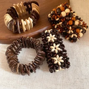 Bohemian multilayer wood bead bracelets with flower and disk patterns on a wooden tray