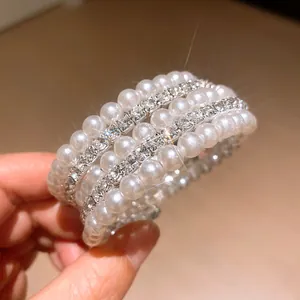 Detailed macro view of multi-layer bracelet with pearls and sparkling rhinestones
