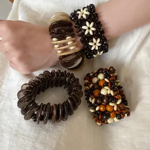Detail of Bohemian multi-layered wooden bead bracelets with natural ethnic flower patterns