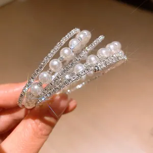 Detailed view of a multi-layer bracelet with sparkling rhinestones and elegant pearls.