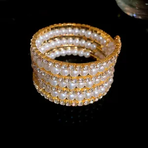 Close-up of retro court style bracelet with multi-layer pearls and sparkling rhinestones