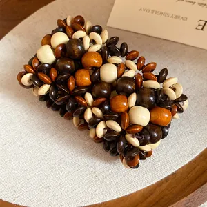 Close-up detail of bohemian multi-layer wooden bead bracelet with floral pattern