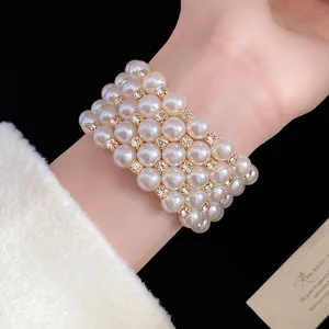 Close-up detail of an elegant multi-layer pearl bracelet featuring sparkling rhinestones