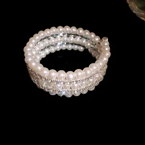Macro view of multi-layer wrap bracelet featuring elegant pearls and sparkling rhinestones.