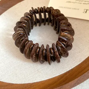 Detailed close-up shot of a brown wooden disc beaded Bohemian ethnic style bracelet.