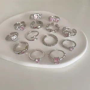 Trendy silver-toned open rings set with pink zircon hearts and geometric designs
