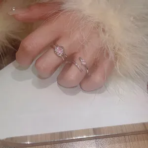Macro view of pink zircon heart open rings on model's hand with soft fur detail