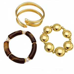 Elegant luxury set of gold-toned metal bangles and brown acrylic pearl bracelets