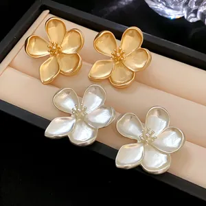 Elegantes pendientes de flor de cinco pétalos en oro y plata con detalles de estambre real