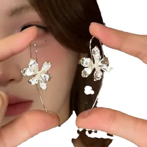 Vintage silver-toned iris flower hook earrings with sparkling crystals shown on model