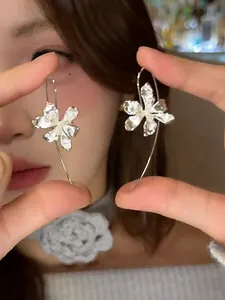 Detail shot of vintage iris flower hook earrings with shimmering crystal petals