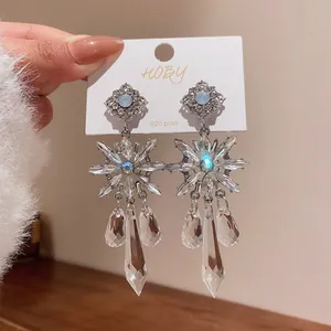 Detail shot of heavy-duty crystal snowflake earrings with 925 silver posts.