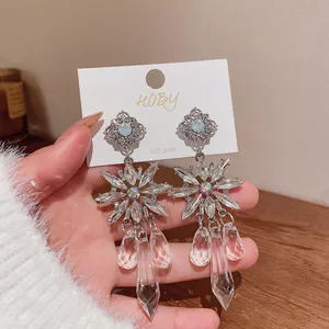 Close-up of sparkling crystal flower drop earrings with 925 silver post details