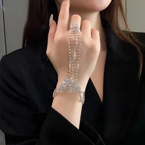 Primer plano de la pulsera de mano con mariposa de strass brillante en la mano