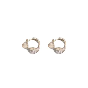 Elegant gold twisted hoop earrings featuring a textured minimalist design on white background