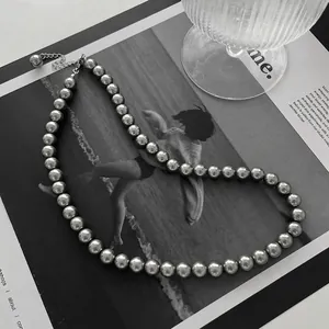 Close-up detail of a silver grey pearl necklace featuring a classic metallic sheen