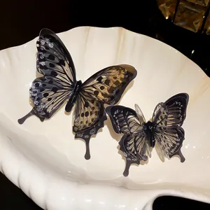 Detail of exquisite transparent butterfly open rings on a decorative white shell prop