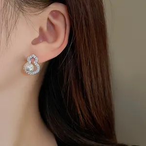 Detailed view of elegant silver gourd-shaped stud earring with zircon and pearl