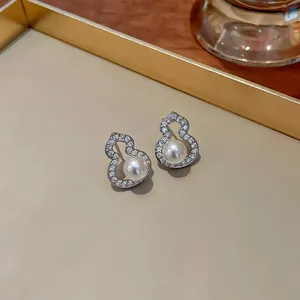 Detailed view of silver needle zircon and pearl gourd stud earrings with elegant design